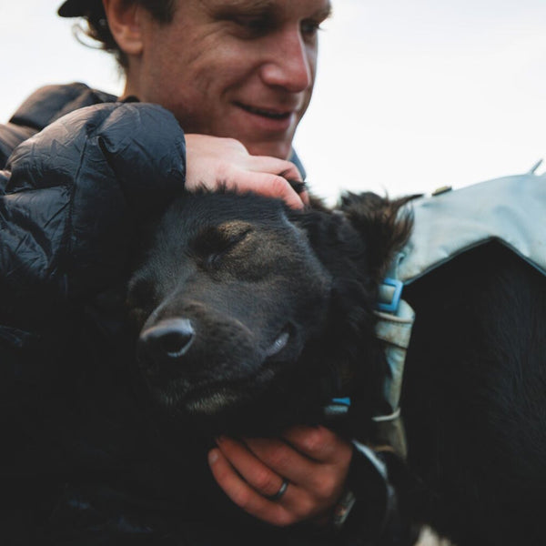 A woman and dog walk together in Scotland