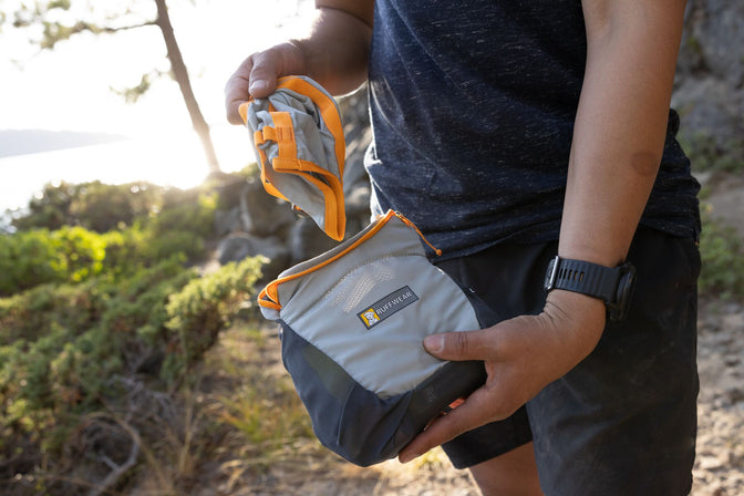 Person holds the BackTrak Evac Kit and the first-aid muzzle